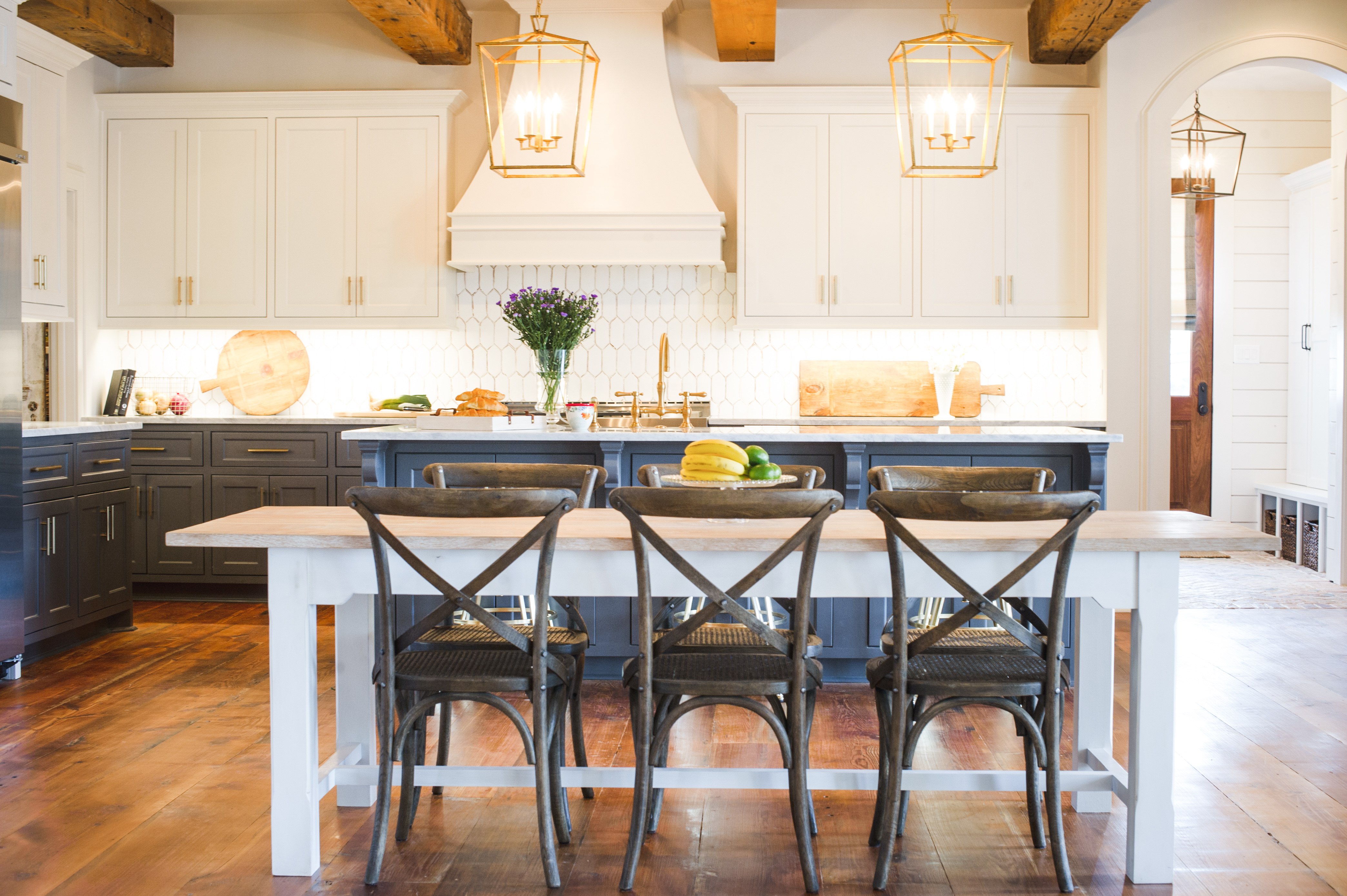 Open kitchen with exposed beams and farmhouse table
