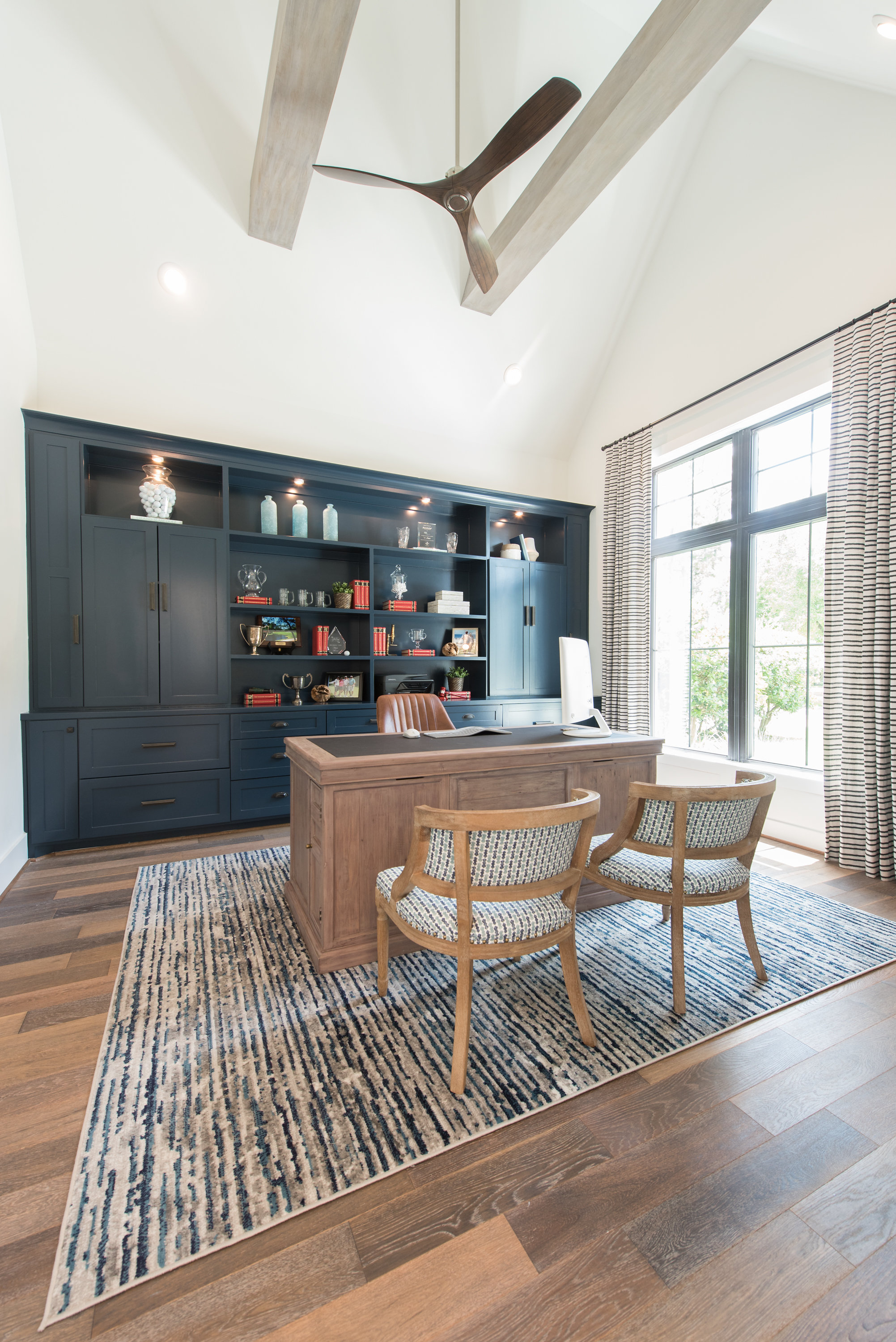 Home office with dark built-in shelving