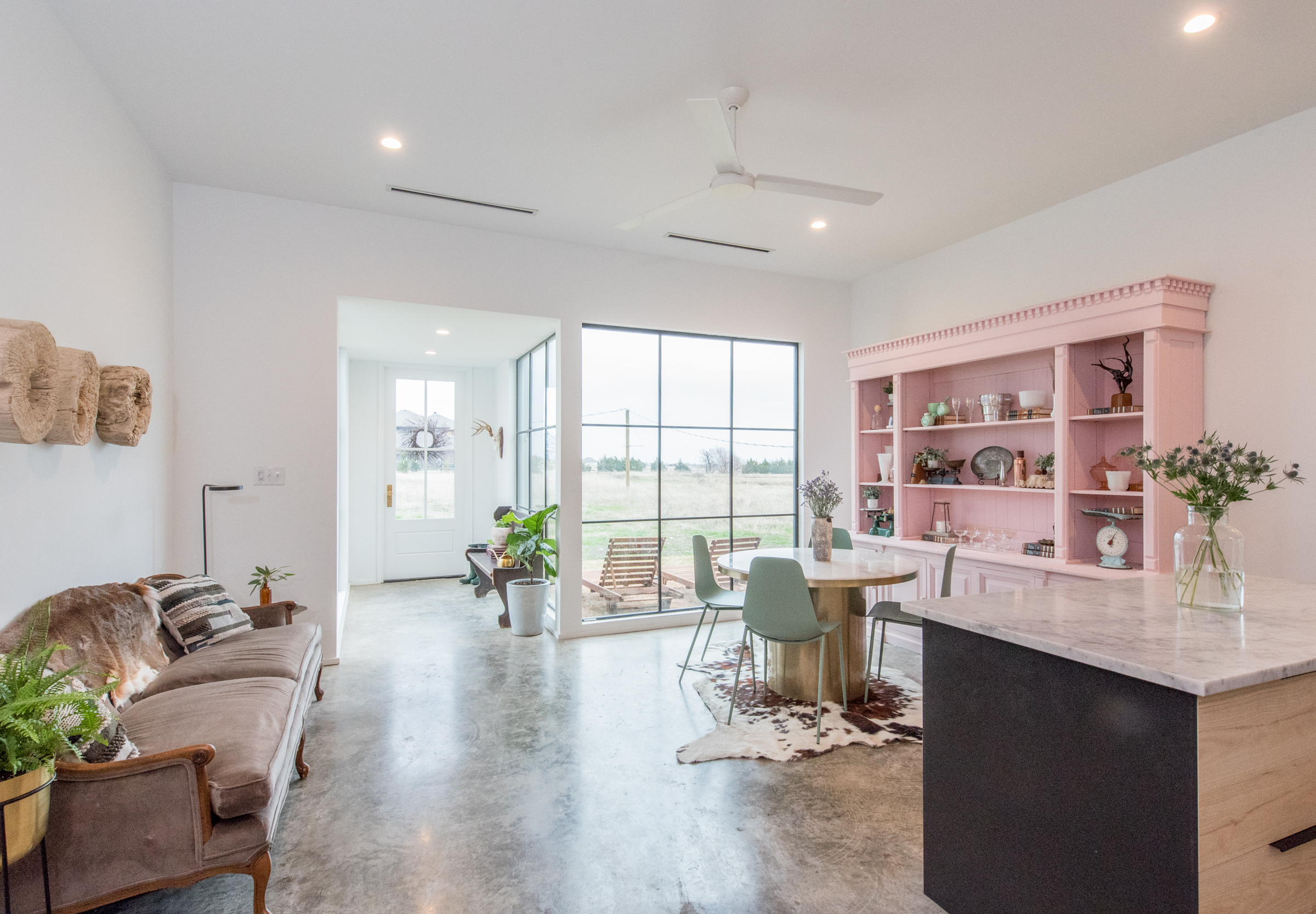 Dining nook with pink shelving and sage chairs